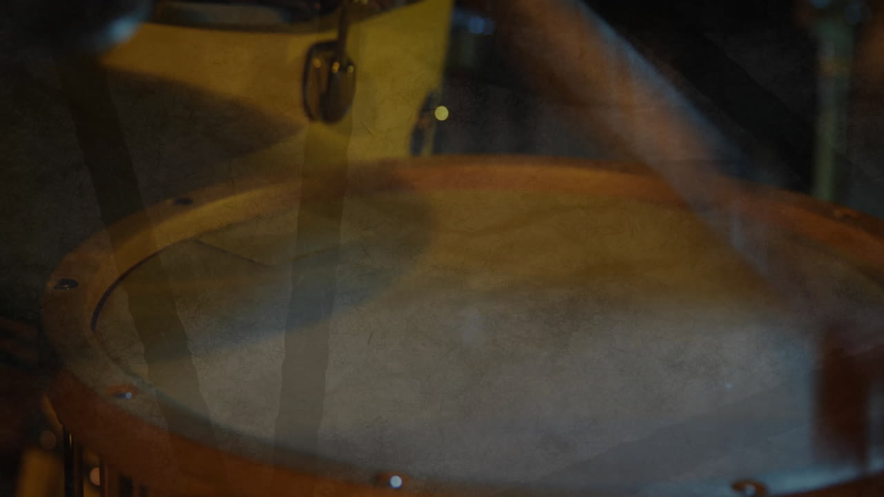 Drum head spinning slowly in 3D render, wooden rim glowing warmly, mallet resting under cymbal