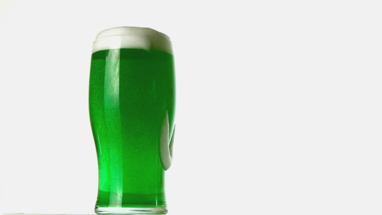 Pint of green beer overflowing