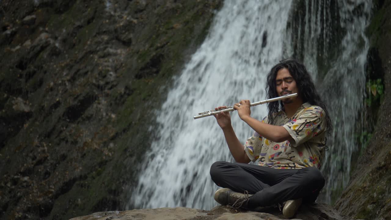 Playing trumpet in a waterfall