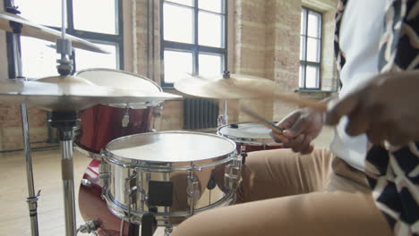 black musician playing drums on rehearsal