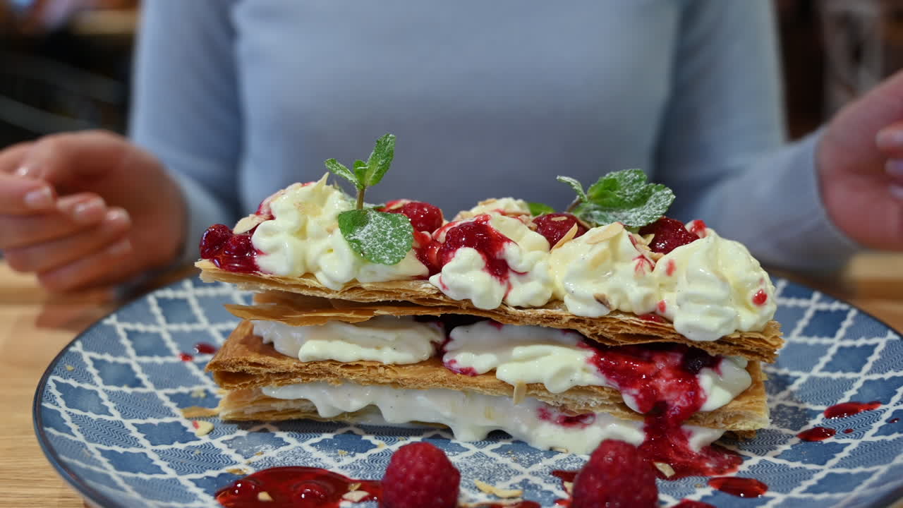 Millefeuille dessert at a restaurant in a blue plate