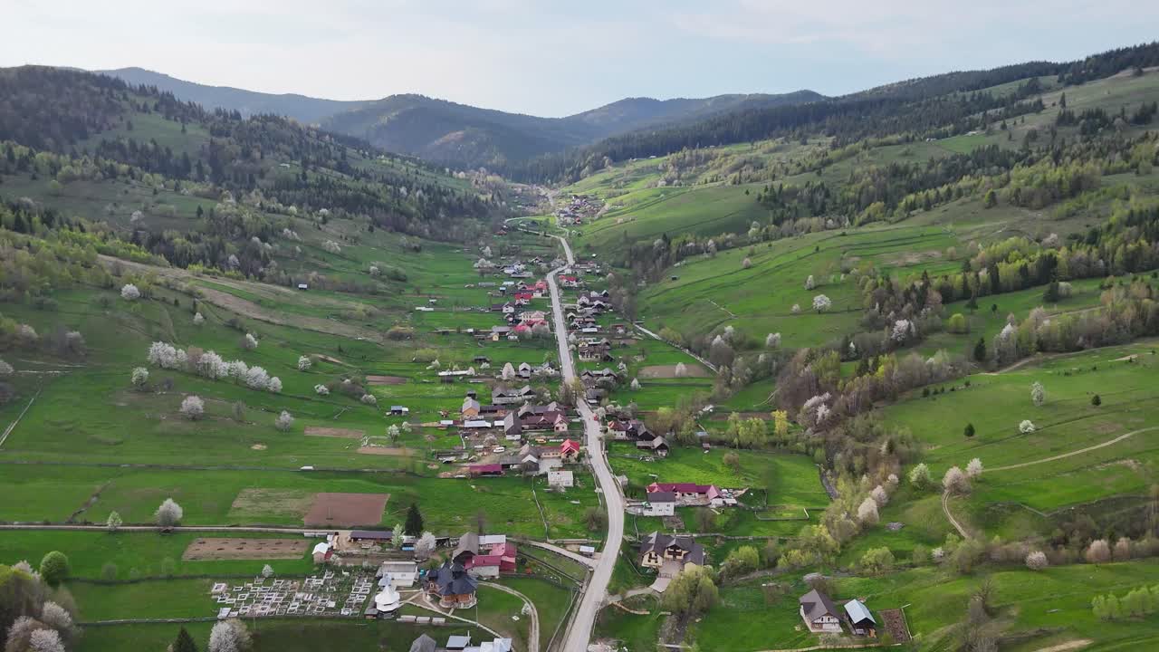 Drone video of Poiana Micului village and the winding road