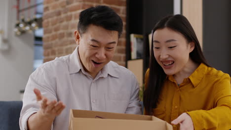 couple excitedly unboxing a gift