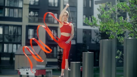 woman ribbon dancing in urban setting