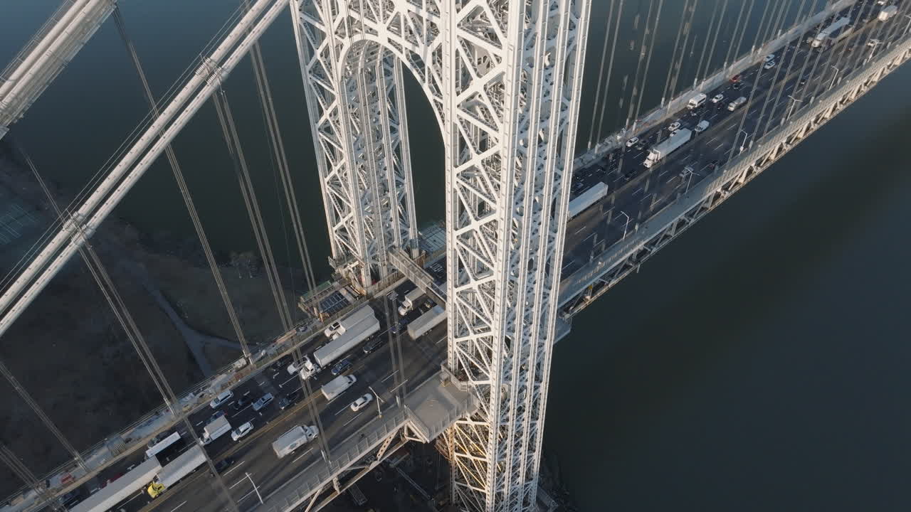 Aerial view of rush hour traffic crossing New York City’s George Washington Bridge. Shot at sunrise.