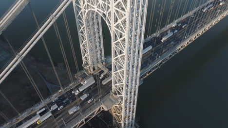 aerial view of rush hour traffic crossing new york city’s george washington bridge. shot at sunrise.