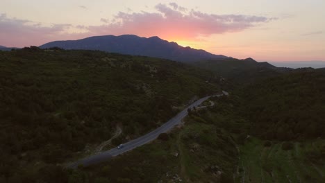 Aerial:-A-car-driving-during-sunset-in-the-mountains-of-the-Greek-island-Samos