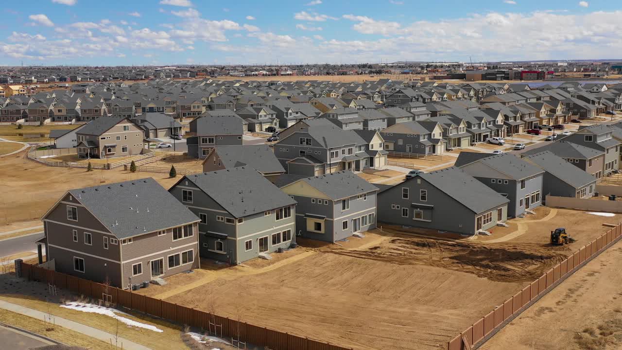 Good aerial over a neighborhood of identical homes under construction in the suburbs 