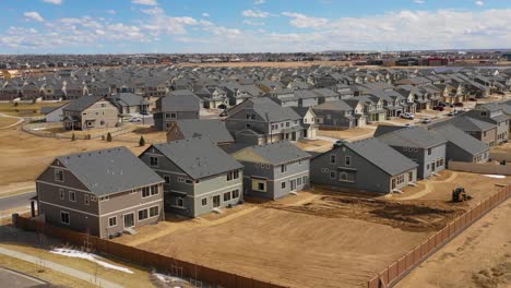 good aerial over a neighborhood of identical homes under construction in the suburbs