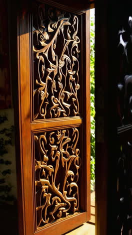 ornamental wooden door opening to a garden