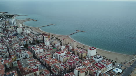 aerial view of coastal city with beach and piers