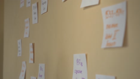 person posting sticky notes on wall