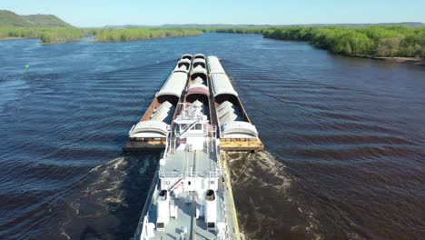 barges being towed on a river