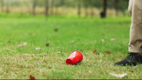 volunteer picking up trash in a park to protect the environment