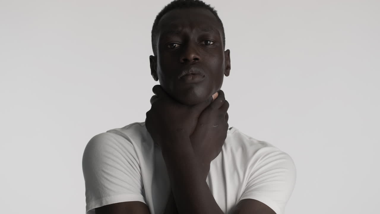 Burdened African american man on grey background.