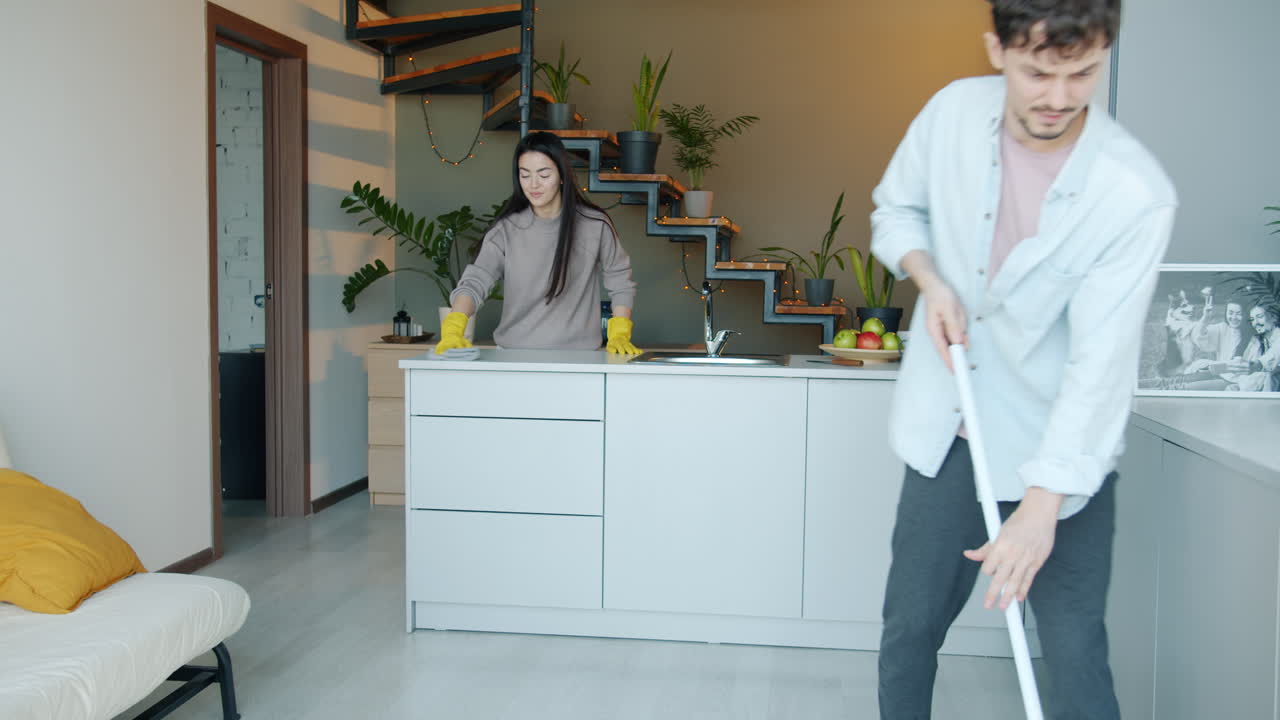 Couple Cleaning Kitchen and Home
