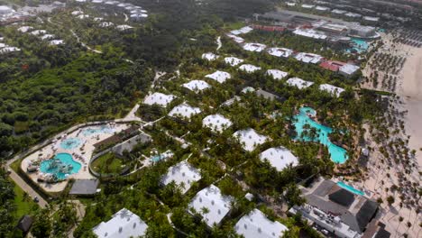 Houses-roofs-and-swimming-pools-in-Bavaro-resort,-Punta-Cana,-Dominican-Republic,-aerial-drone-view