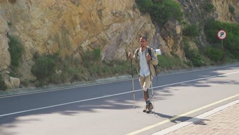 sporty mixed race man with prosthetic leg hiking