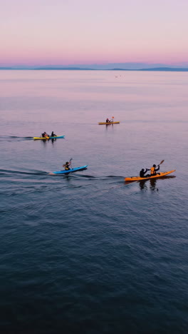 kayaking on calm water at sunset or sunrise