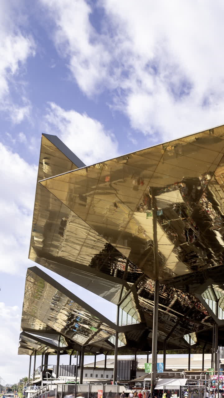 Timelapse of the encants second hand market with gloden reflecting roof in barcelona in vertical