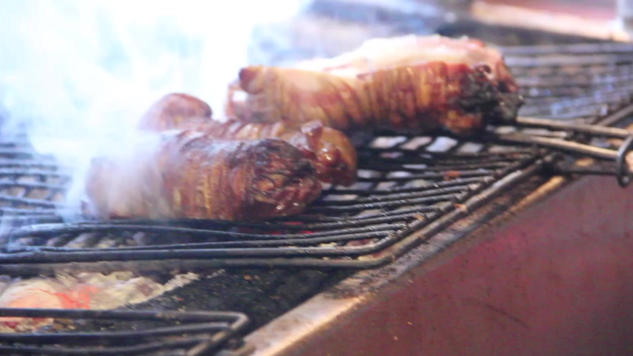 Grilled meat cooking. grill smoke. cut the meat with the help of a sharp knife. the smoke from the grill smoke. lamb beef waiting to cook. it's a piece of delicious lamb. kokorec of turkey