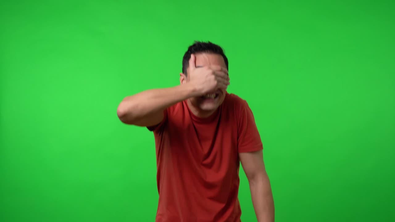 Man covering his eyes with his hand.