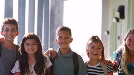 a group of schoolchildren in front of school in summer