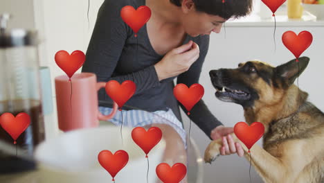 animation of red heart balloon icons over caucasian woman with pet dog