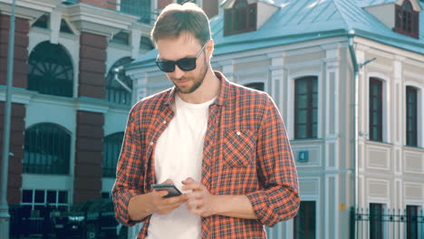 man using smartphone outdoors