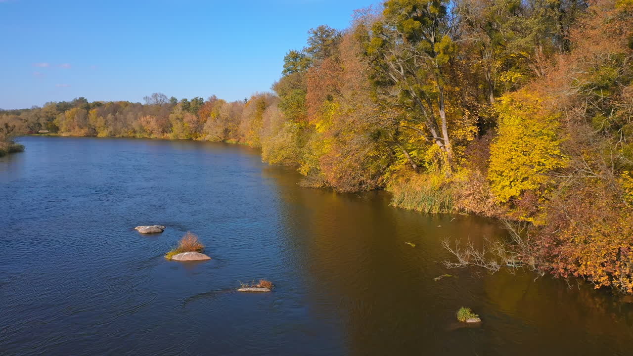 Beautiful autumn river drone view. Orange colors landscapes aerial view.