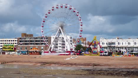 ferris wheel spins at beachside carnival event