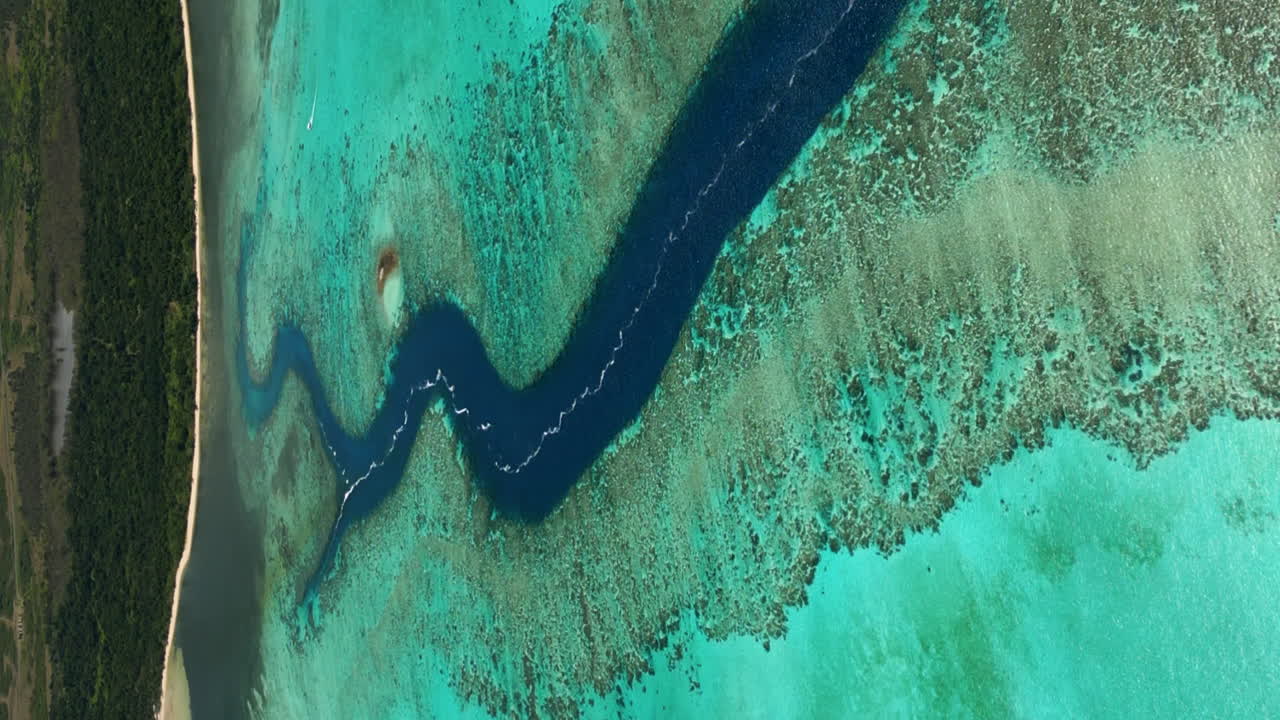 Flyover, vertical format, over Shark Fault in Grande Terre, New Caledonia, towards Po&eacute; Beach