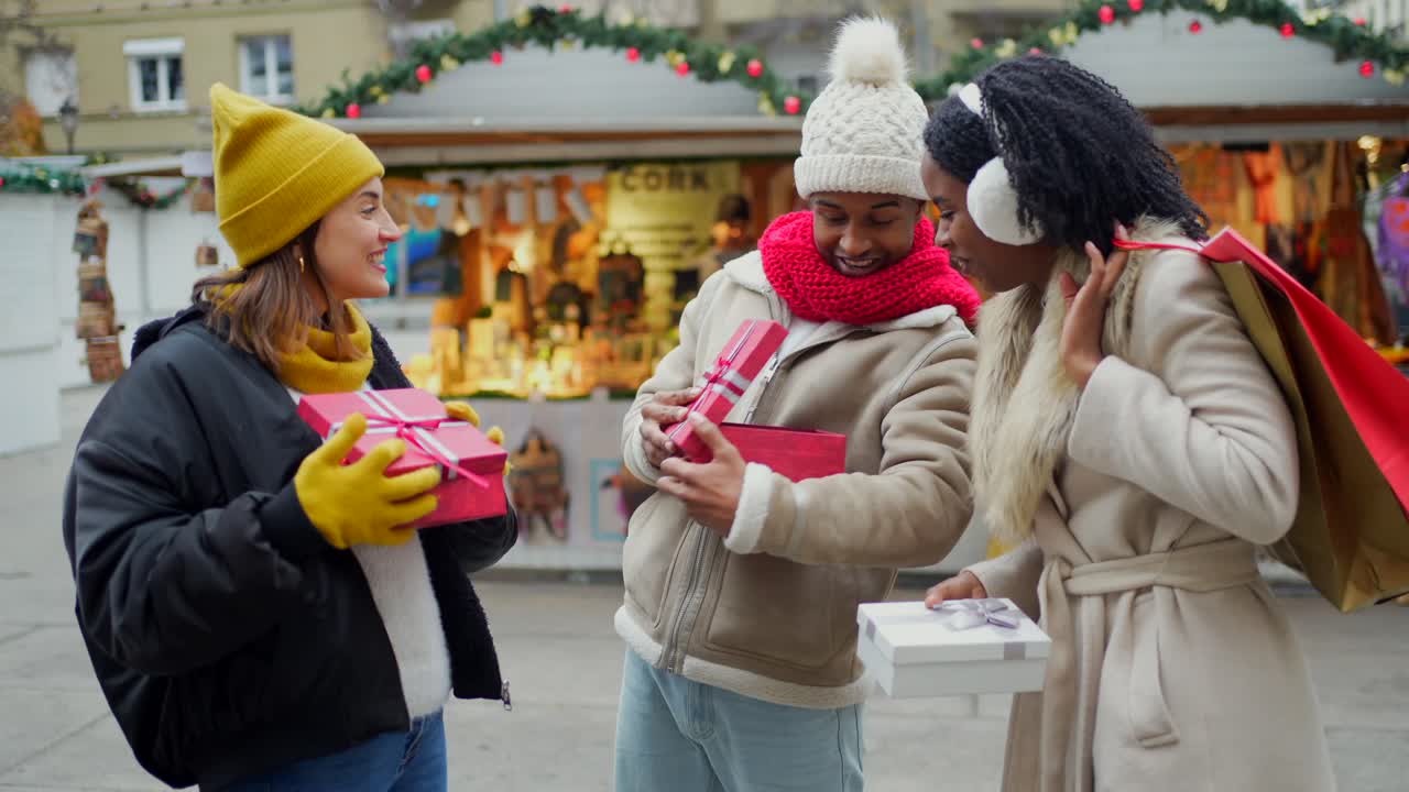 Friends Exchanging Christmas Gifts at a Market