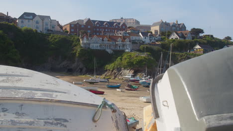 the harbour hotel in the background view from the shore with docked boats on a sunny day in newquay harbour, cornwall, england, uk