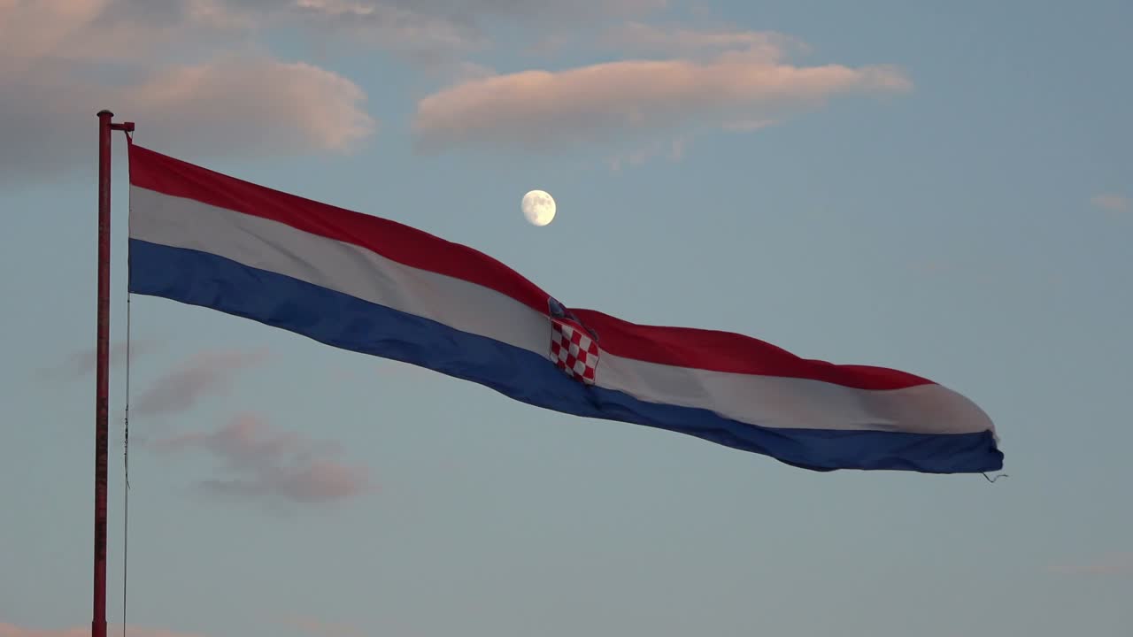 4K. Large flag of Croatia waving in the wind. It is getting dark