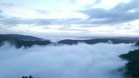 dense fog covering sil canyon on cloudy dark morning, galicia, spain