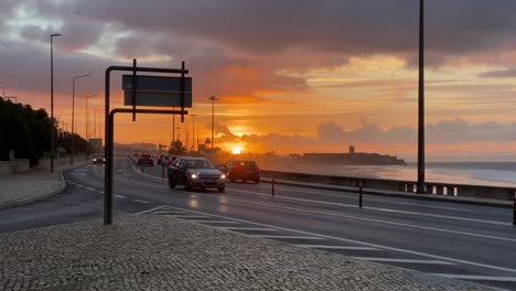 silhouette cars moving marginal road with a golden sunrise at golden hour in honey sun or travel concept