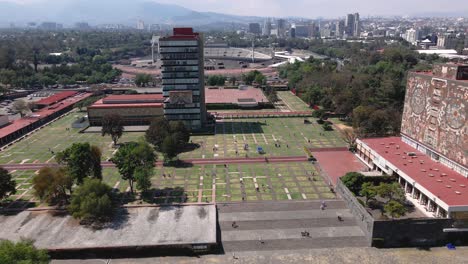 wide rising aerial view of the ciudad universitaria campus in mexico city