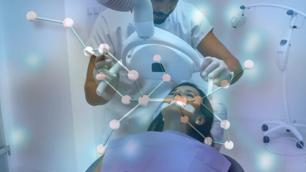 Animation of chemical formulas over caucasian male dentist and female patient