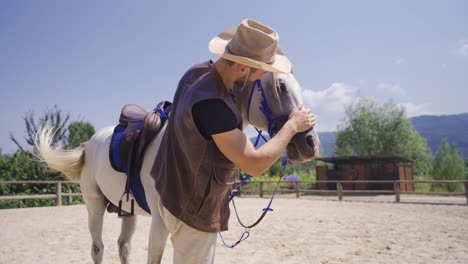 The-man-getting-off-the-horse-kisses-the-horse-and-leaves.