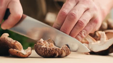 chef chopping shiitake mushrooms