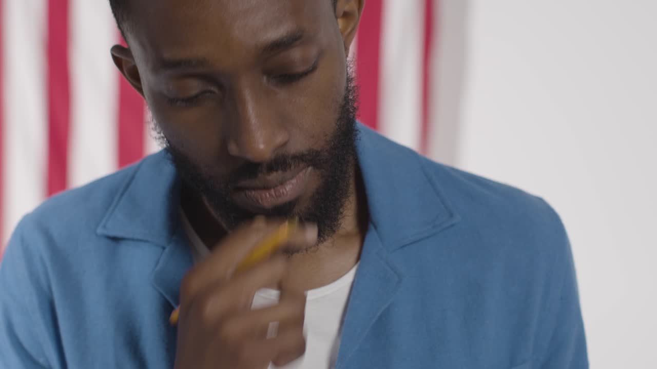 Man Stands At Ballot Box In American Election Deciding How To Cast His Vote 1