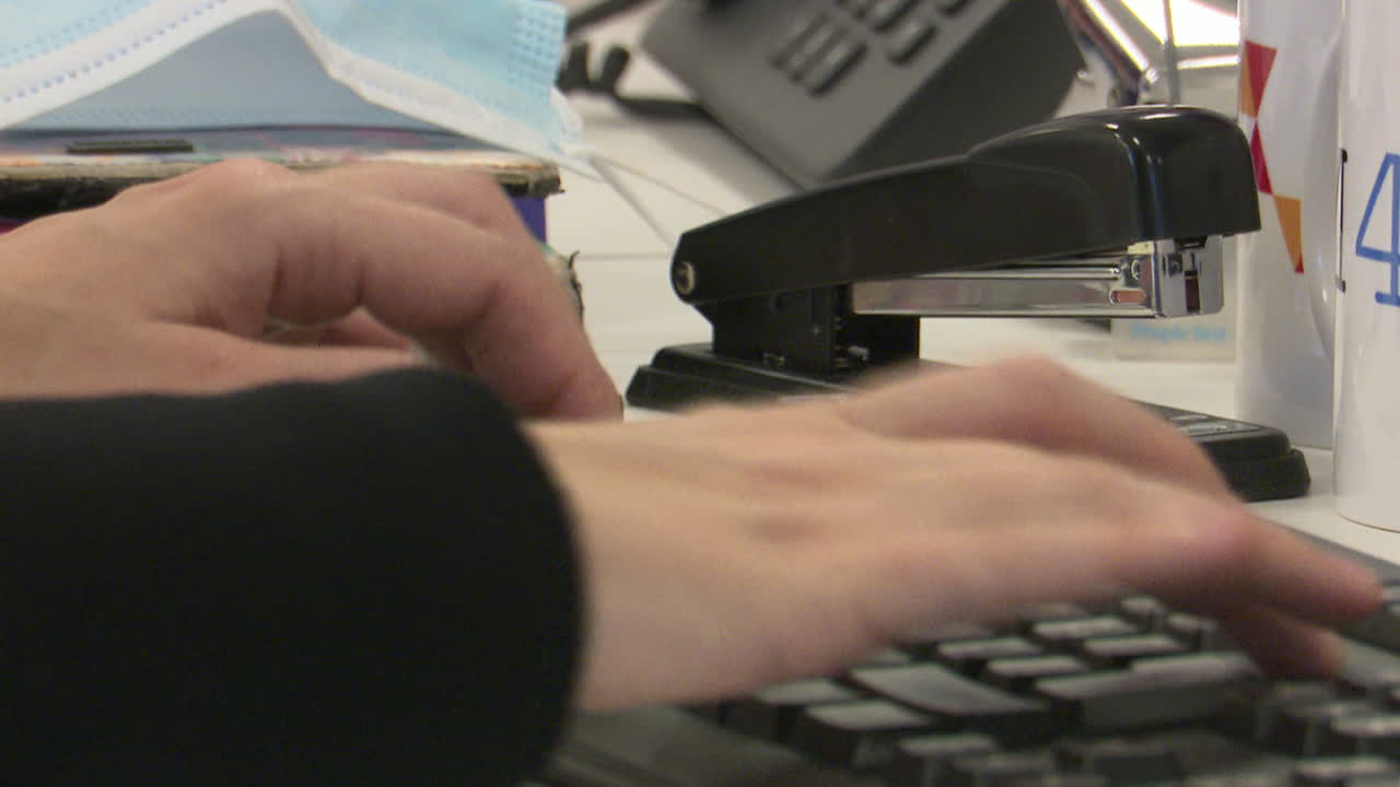 Person typing on a computer at a desk