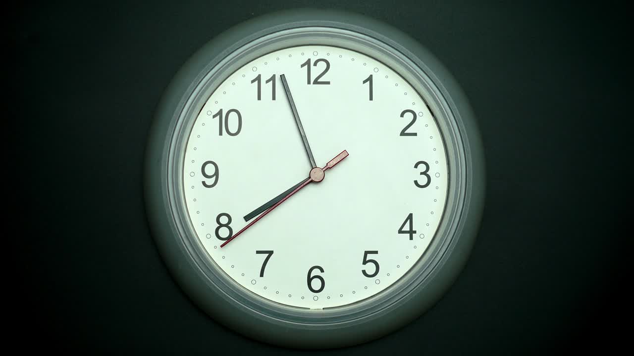 Front view,  White wall clock. Tell the time in four minutes until eight o'clock.