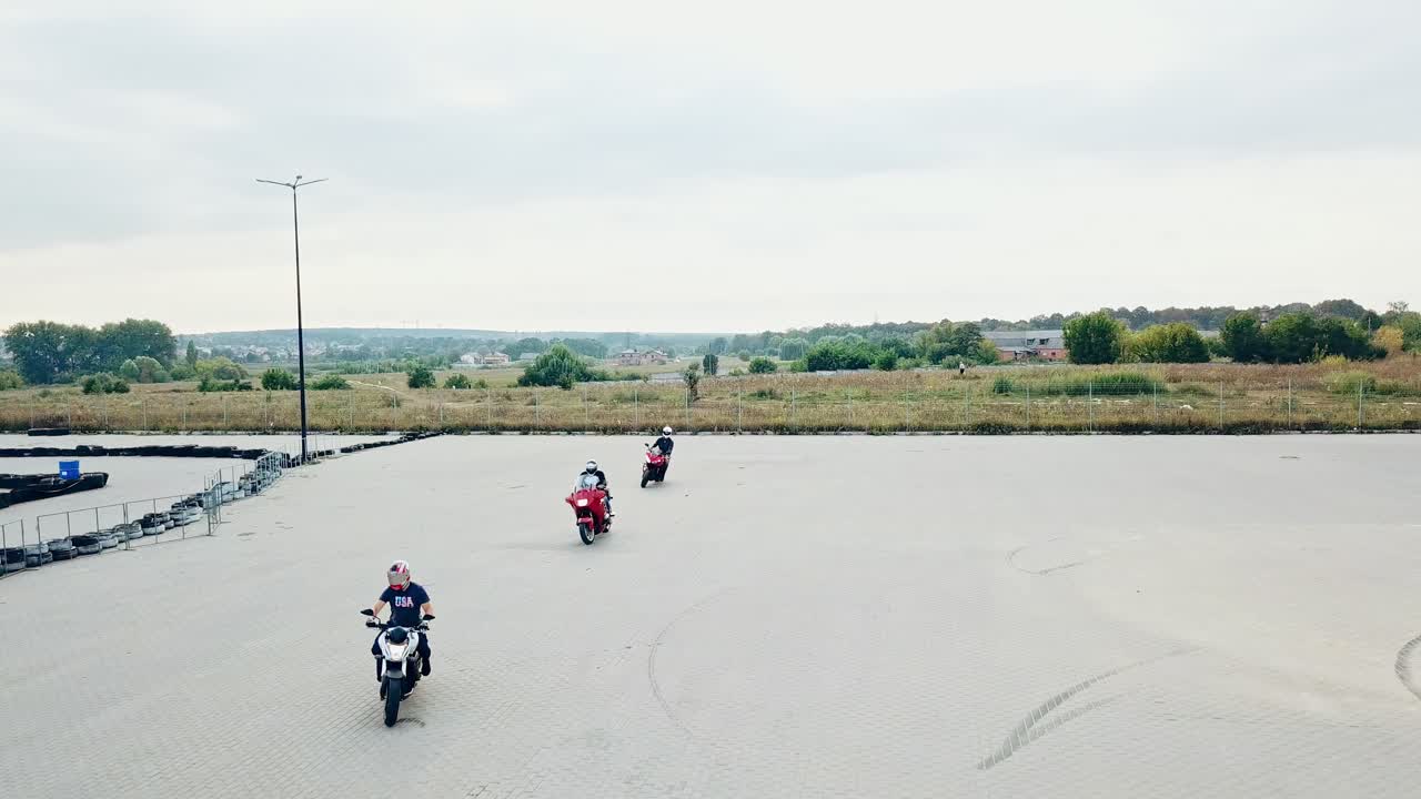 Small group of motorbikers. Motorcycle having fun driving on empty parking road