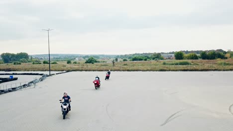 small group of motorbikers. motorcycle having fun driving on empty parking road