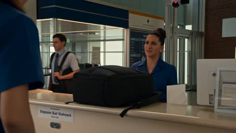 People at an airport check-in counter