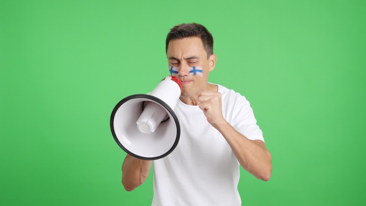 Excited man with finnish flag on face using a megaphone