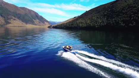 people sailing in jet boat on new zealand lake taylor - dolly in shot