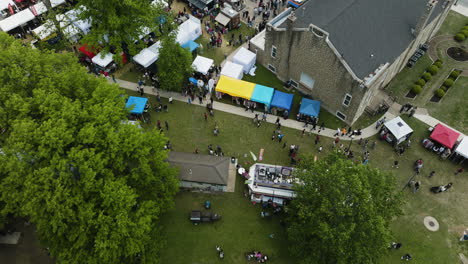 aerial view of people wandering around stalls at the dogwood festival in siloam springs, arkansas